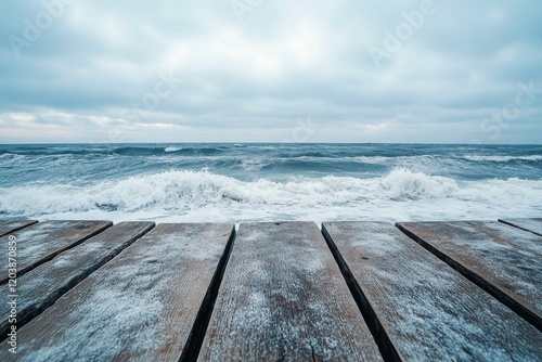 Breathtaking view of serene ocean from wooden deck under clear sky at midday