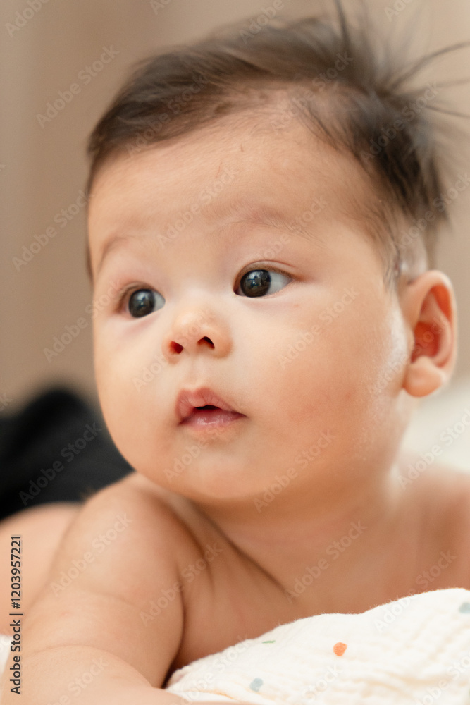 a close up of a baby laying on a blanket a close up of a baby laying on a blanket