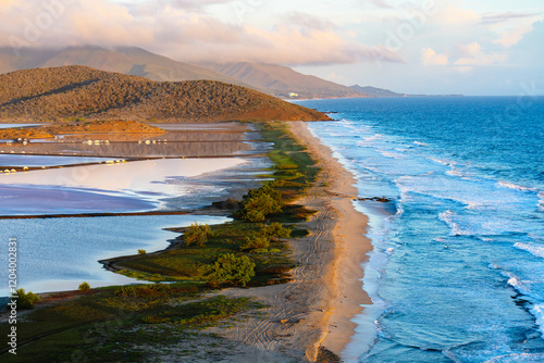 Majestic Mountainous Coastline Bathed in Warm Light. Pampatar salt flats, Margarita, Venezuela photo