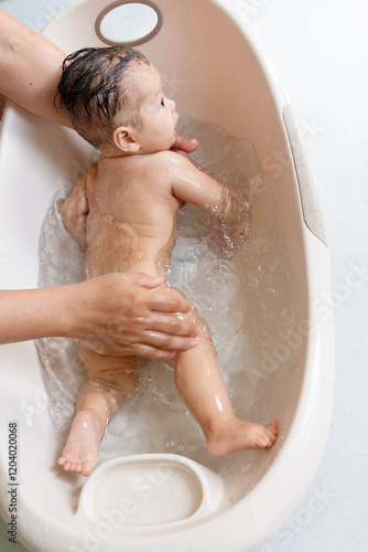 a baby taking a bath in a bathtub