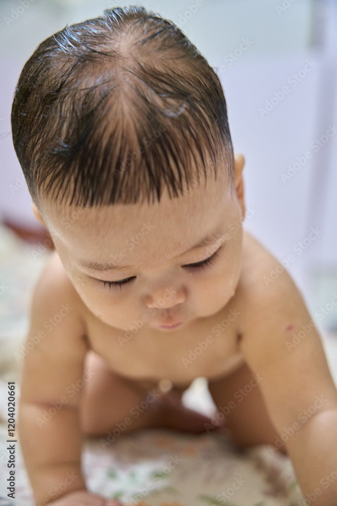 there is a baby that is crawling on a bed with a teddy bear there is a baby that is crawling on a bed with a teddy bear