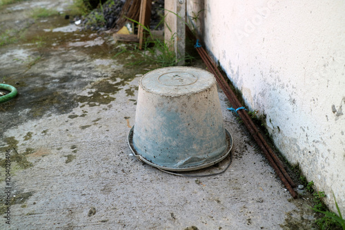 Dirty used cement bucket, upside down outside