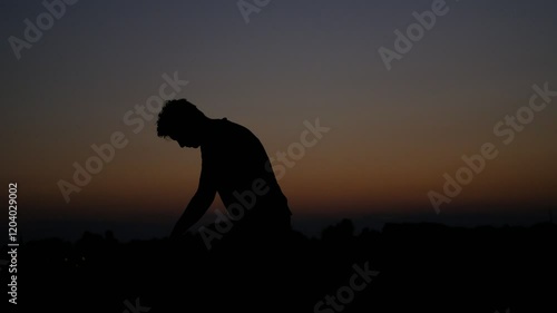 Teenager silhouette wearing hat