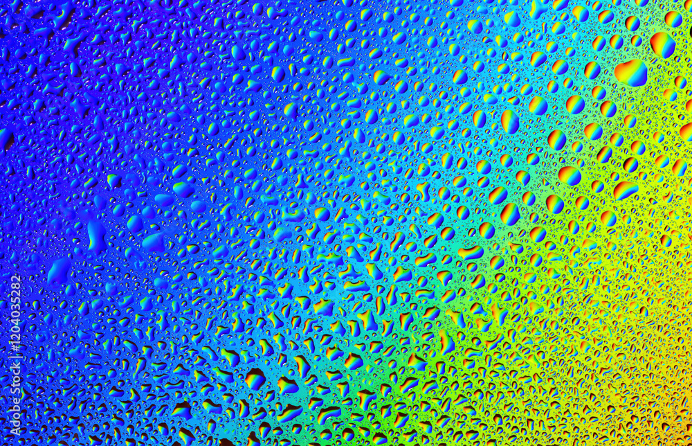Vibrant droplets of water create a colorful abstract masterpiece on glass surface