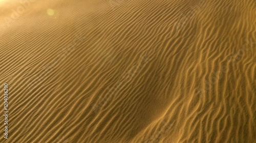 Sand waving in the wind in dunes in desert. Wind blows sand off the dune and carries it away. Sandstorm in the desert