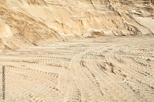 Excavator wheel marks in a sand quarry