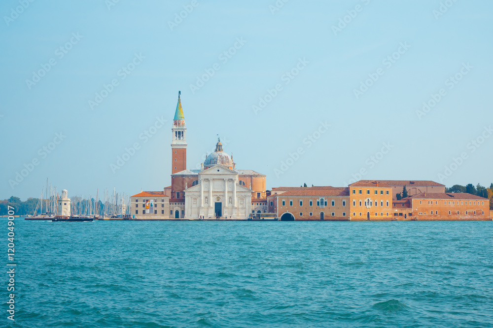 A picturesque view of San Giorgio Maggiore island in Venice, Italy, featuring its iconic bell tower and historic architecture surrounded by calm waters. Perfect for travel and cultural themes. A picturesque view of San Giorgio Maggiore island in Venice, Italy, featuring its iconic bell tower and historic architecture surrounded by calm waters. Perfect for travel and cultural themes.