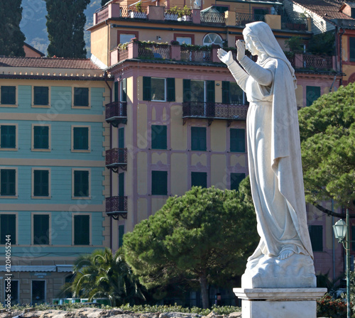 Santa Margherita, Italy - November 13, 2024. Statue against sky and traditional buildings. Tourism and recreation. Faith and religion.  photo