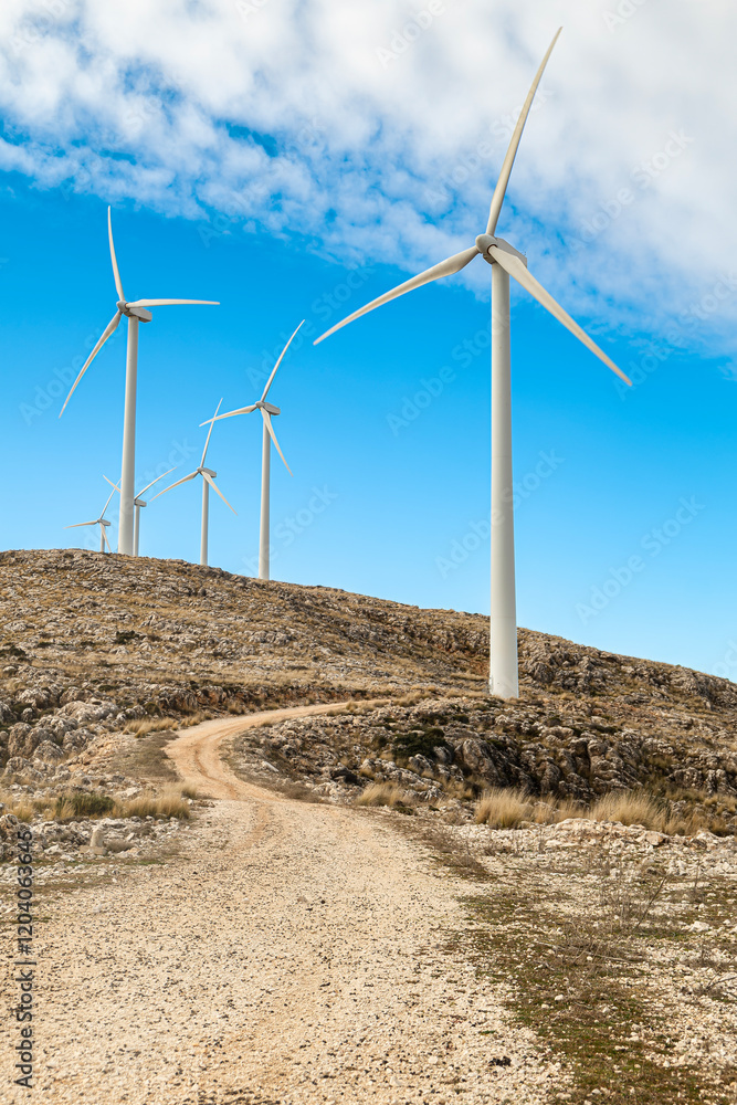 Wind turbine in the foreground: renewable energy in vertical perspective Wind turbine in the foreground: renewable energy in vertical perspective