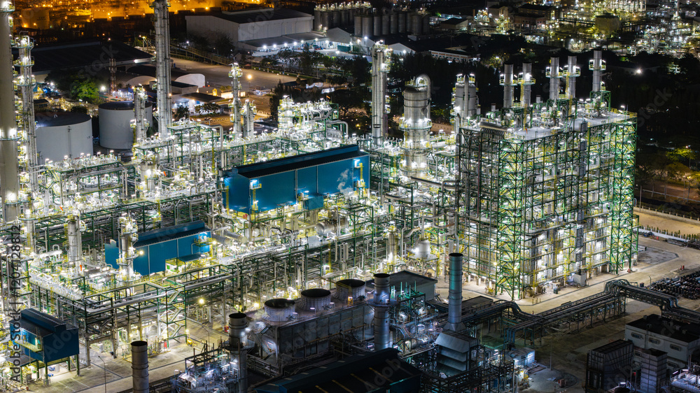 Obraz premium Illuminated Industrial Refinery at Night
