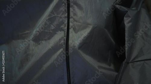 Pathologist zips bodybag with deceased man