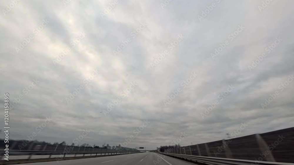 Driving on an empty highway on a cloudy day. Driving on an empty highway on a cloudy day.