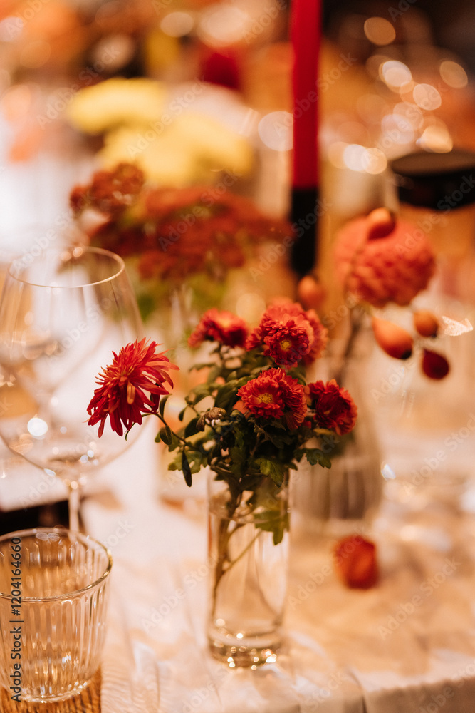 Elegant floral table centerpiece with red flowers, creating a romantic and festive ambiance Elegant floral table centerpiece with red flowers, creating a romantic and festive ambiance