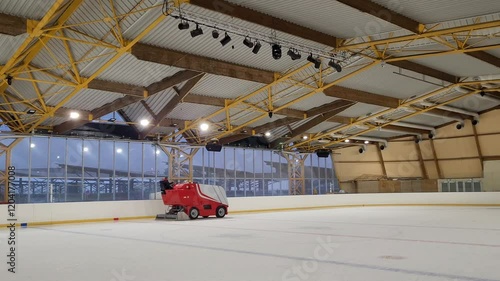 An ice resurfacer smooths the ice of an ice rink photo