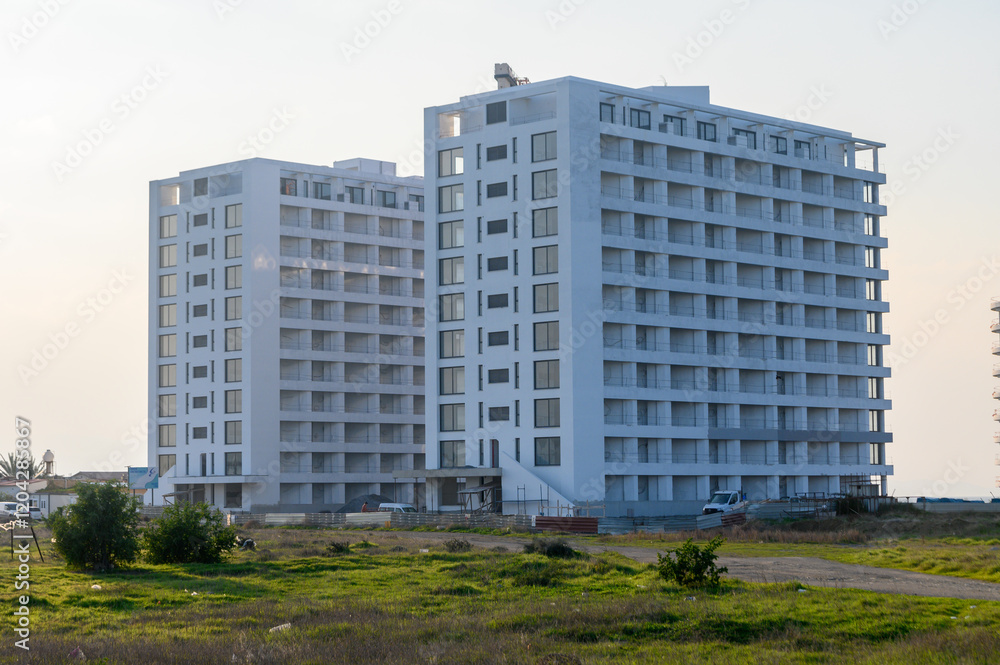 Modern apartment buildings rise against a clear sky in a tranquil urban setting Modern apartment buildings rise against a clear sky in a tranquil urban setting