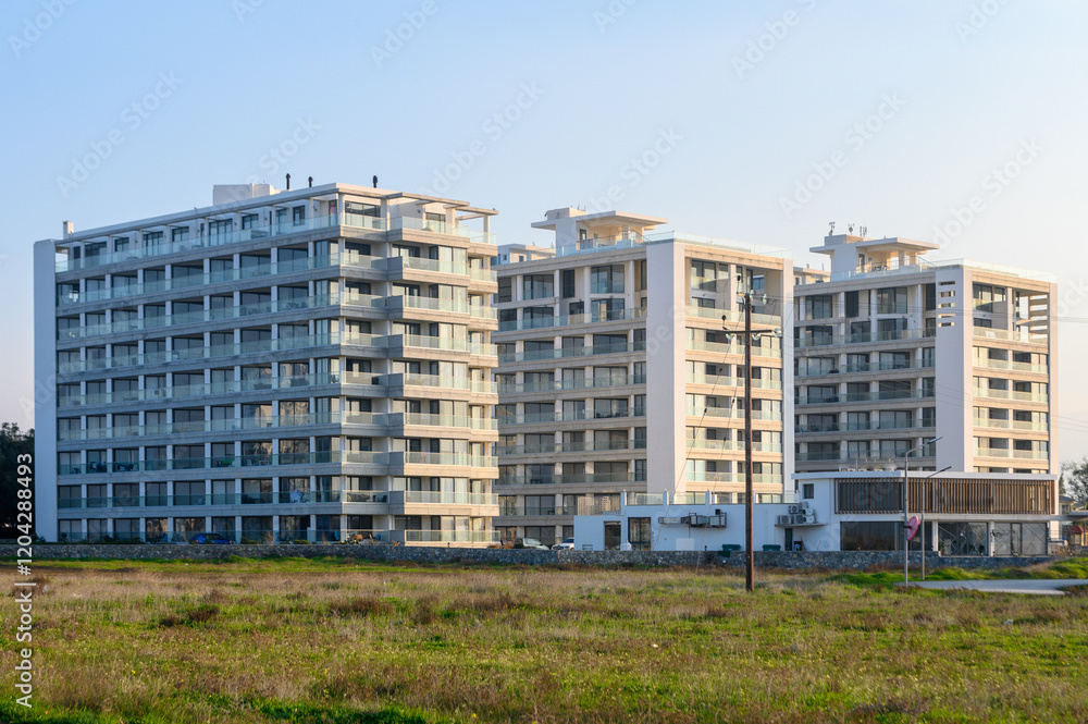 Modern residential buildings rise amidst lush greenery in a tranquil setting during golden hour Modern residential buildings rise amidst lush greenery in a tranquil setting during golden hour