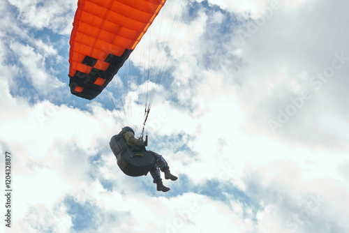 Paraglider under orange dome on sky background close-up. Copy space.