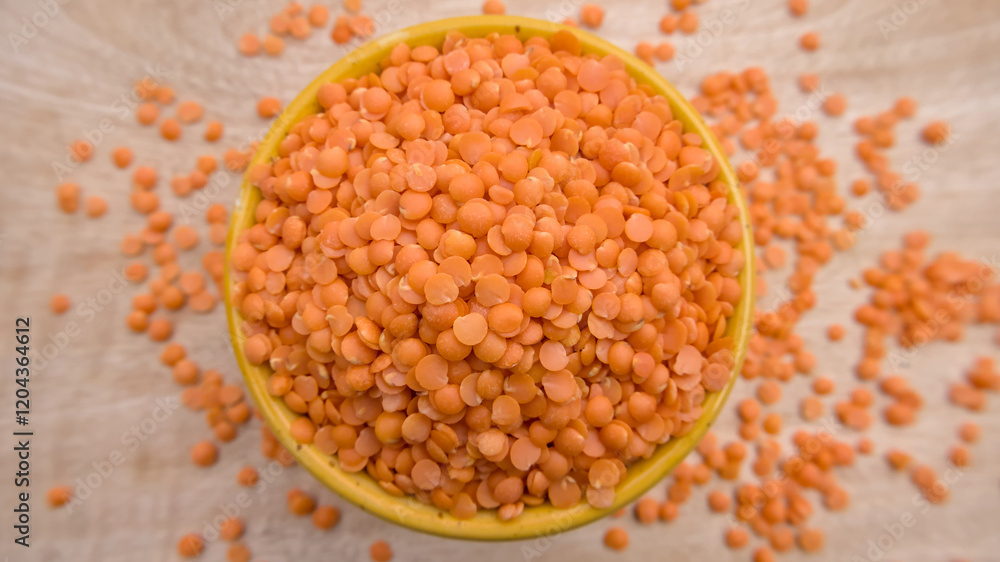 Red Lentils (Masoor Dal) Split and Dehusked in a Yellow Bowl - Rustic Close-Up Top View Flat Lay Red Lentils (Masoor Dal) Split and Dehusked in a Yellow Bowl - Rustic Close-Up Top View Flat Lay