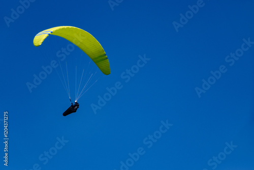 Fototapeta Naklejka Na Ścianę i Meble -  Paraglider flight against a beautiful blue sky. Beskidy Mountains, Poland