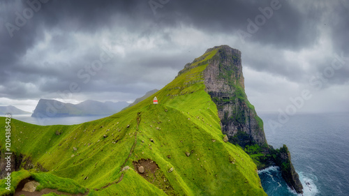 Kallur Lighthouse, Kalsoy Island, Faroe Islands, Denmark. Lighthouse on top of the mountain. Scenic  view of the rocks and the ocean. Photography for background, wallpaper, postcards. photo