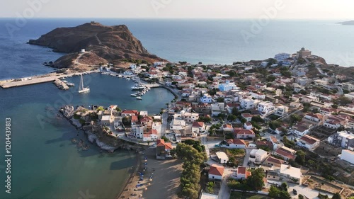 Aerial drone cinematic video of picturesque and historic main village of Psara island featuring landmark church of Saint Nikolas, North Aegean islands, Greece photo