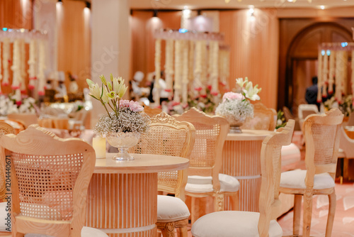 Canvastavla Elegant event space with light wood chairs and floral centerpieces
