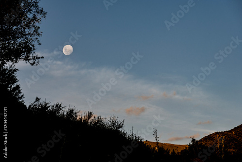 Moon at dusk over the mountains of Córdoba, in Villa Giardino. photo