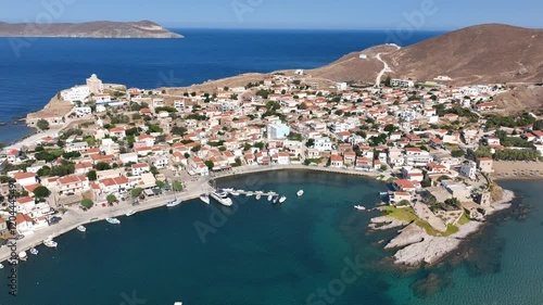 Aerial drone cinematic video of picturesque and historic main village of Psara island featuring landmark church of Saint Nikolas, North Aegean islands, Greece photo