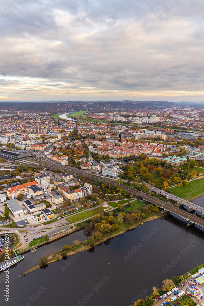 Fototapeta premium Beautiful view of city of Dresden from hot air balloon. Elbe River flows through city creating picturesque landscape, houses, bridge. Germany. Aerial view Dresden