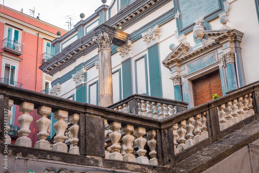 Ornaments on a church or monastery with pillars and handrails at via tribunati in napoli downtown.