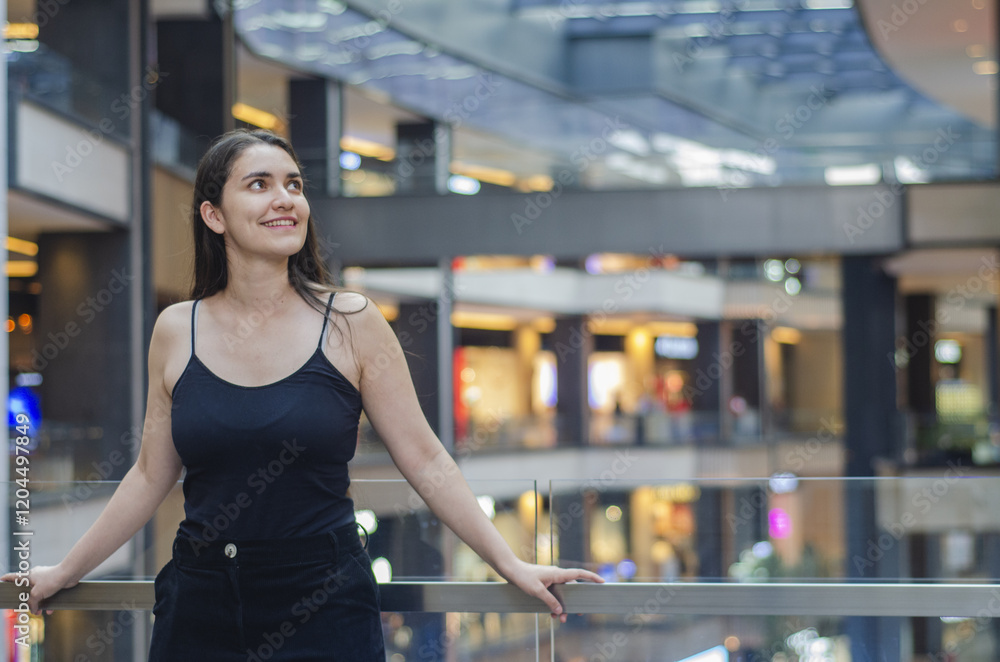 Cheerful latin Woman Enjoying Modern Shopping Mall Environment. Smiling Mexican young woman leaning on a railing in a modern shopping mall, surrounded by stylish architecture. Cheerful latin Woman Enjoying Modern Shopping Mall Environment. Smiling Mexican young woman leaning on a railing in a modern shopping mall, surrounded by stylish architecture.