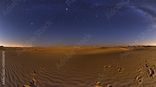 Starry night sky over a desert landscape with footprints in the sand.