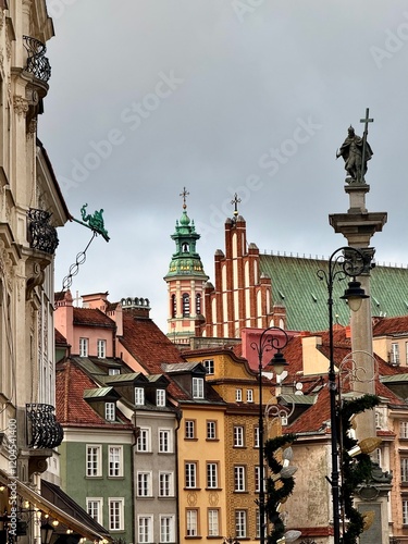 view of colorful old buildings of warsaw old town with roofs and bell tower during christmas time
