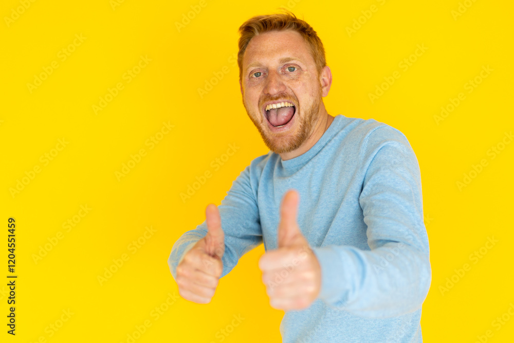 Excited redhead man smiling widely and giving a thumbs up against a vibrant yellow background, radiating positivity and joy Excited redhead man smiling widely and giving a thumbs up against a vibrant yellow background, radiating positivity and joy
