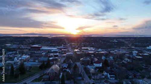 Saint Albans, Vermont drone video - Aerial drone footage flying over the downtown area of the small village of Saint Albans in northern Vermont with sunset over Lake Champlain