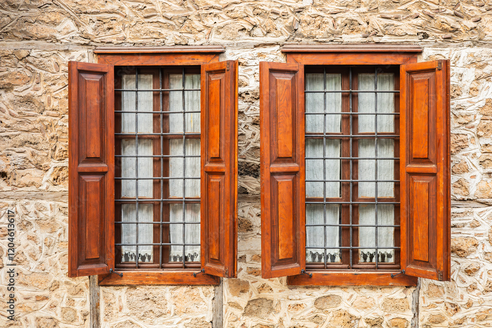 Rustic stone wall with wooden shuttered windows Rustic stone wall with wooden shuttered windows