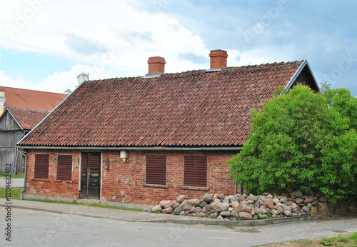 Vintage brick home with high pitched roof in Kuldiga, Latvia photo