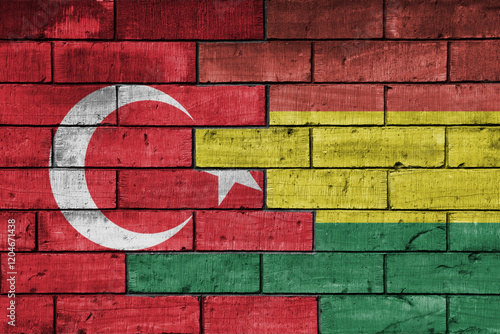 Fototapeta Naklejka Na Ścianę i Meble -  colourful painted big flag of turkey and flag of bolivia on a massive old brick wall background. concept