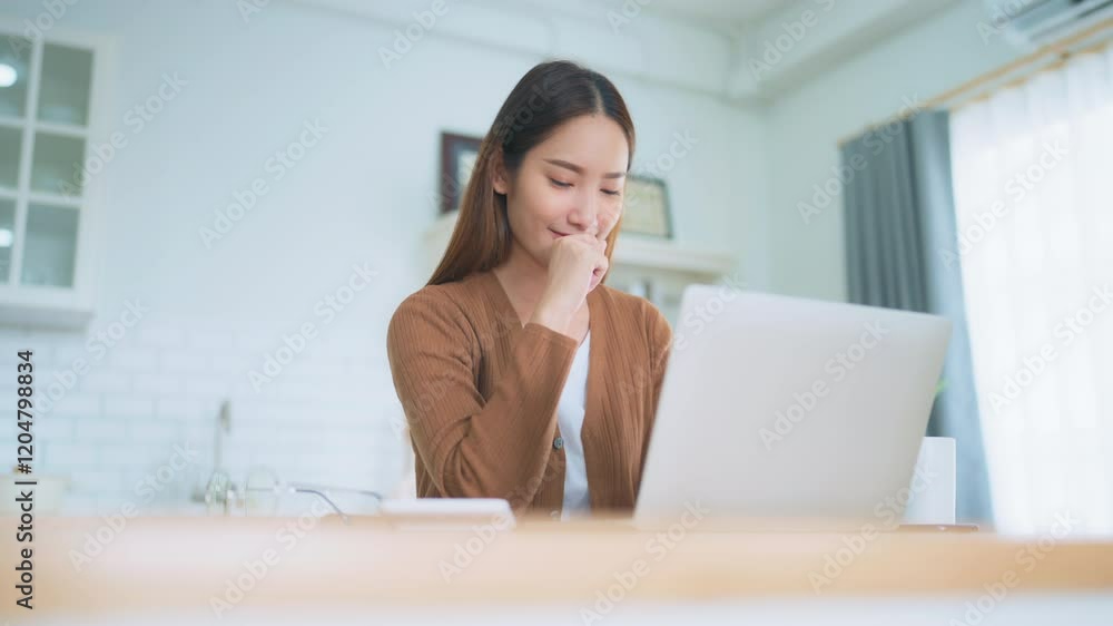 Beautiful young Asian woman working with laptop computer in home kitchen. Work at home Beautiful young Asian woman working with laptop computer in home kitchen. Work at home
