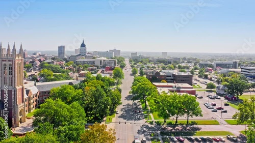 Aerial establishing shot of the Kansas Statehouse and Topeka skyline with forward motion along 10th street. Topeka is the capital city of the U.S. state of Kansas and the county seat of Shawnee County