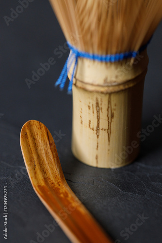 Closeup of Chasen or Bamboo whisk and Chashaku or tea scoop, equipments for preparing matcha green tea.