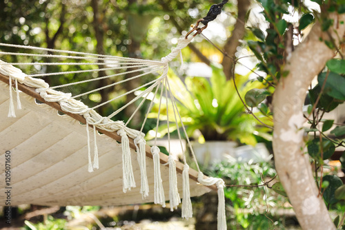 Canvas Print Cotton hammock with tassels in tranquil tropical garden