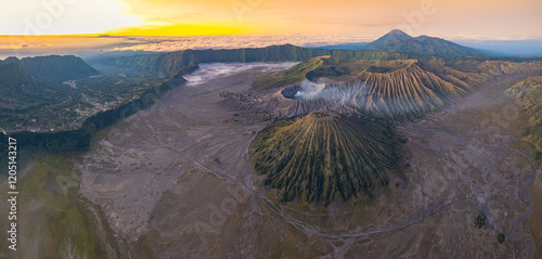 Bright morning colors on the horizon..The sun shines brightly over the sea of ​​mist at Bromo Volcano, Indonesia. At the top of the steep mountain you can see a volcanic crater and a sea of ​​mist. photo