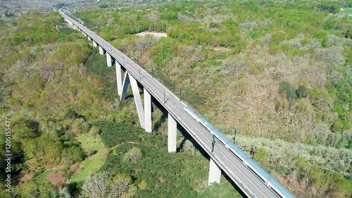 spanish high speed train running over a viaduct, aerial footage from a drone