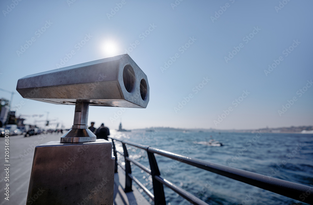 Coastal Viewpoint With Fixed Binoculars Overlooking Sunny Waterfront Coastal Viewpoint With Fixed Binoculars Overlooking Sunny Waterfront