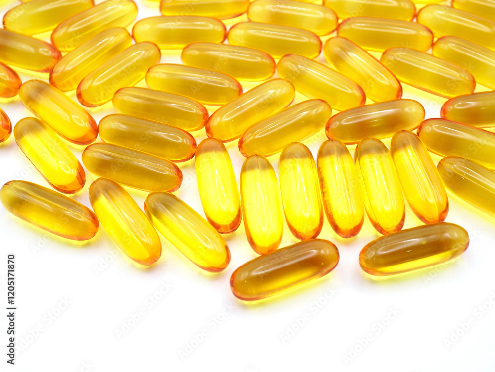 A close-up image of fish oil capsules placed on a white background. Fish oil capsules as a background, backdrop, texture, or pattern A close-up image of fish oil capsules placed on a white background. Fish oil capsules as a background, backdrop, texture, or pattern