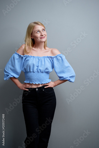 Wallpaper Mural Confident Young Woman in Stylish Blue Top Posing Against Grey Background.. Torontodigital.ca