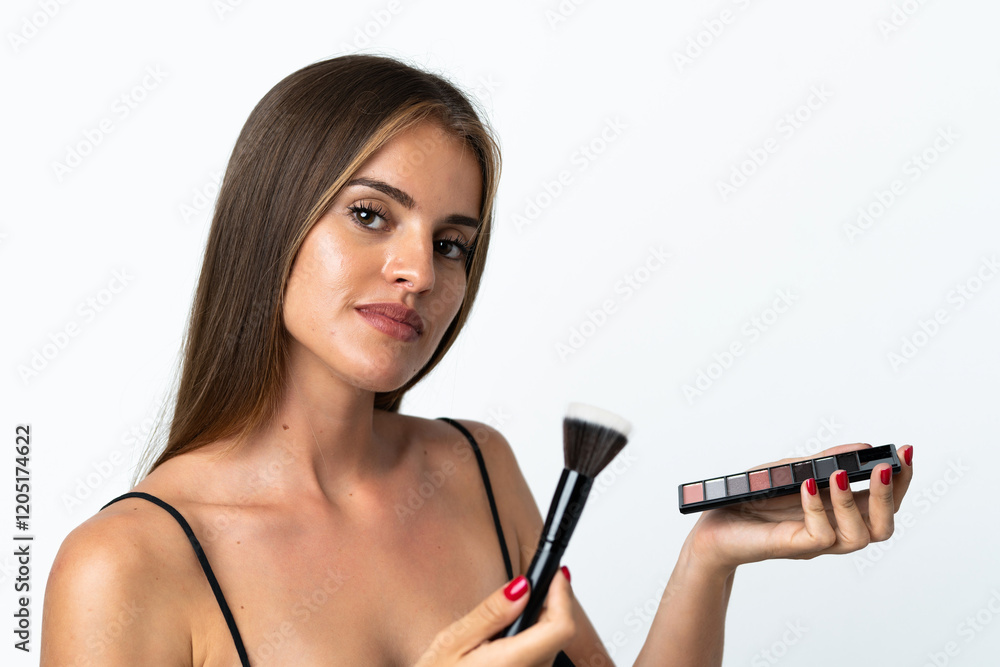 Young Uruguayan woman isolated on white background with makeup palette Young Uruguayan woman isolated on white background with makeup palette