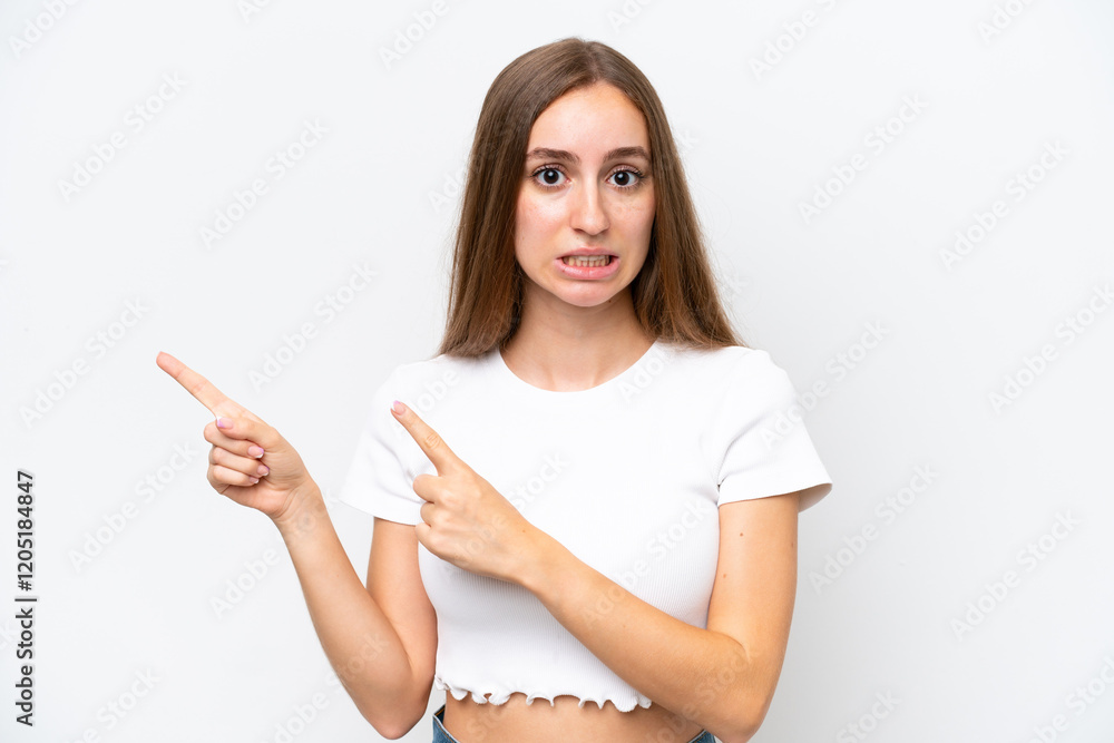 Young caucasian woman isolated on white background frightened and pointing to the side Young caucasian woman isolated on white background frightened and pointing to the side