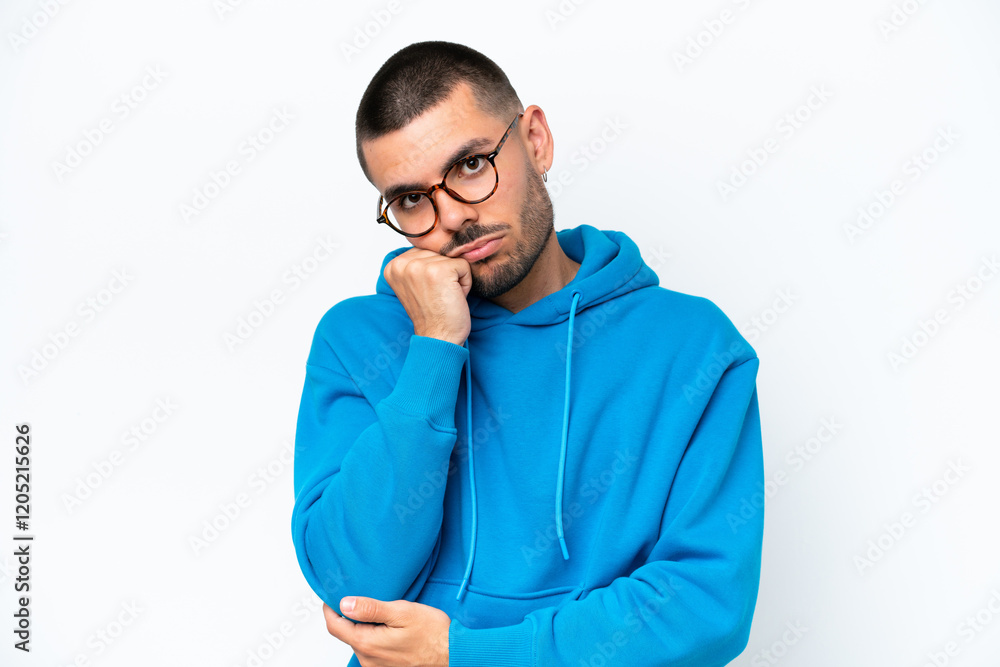 Young caucasian man isolated on white background With glasses and with sad expression Young caucasian man isolated on white background With glasses and with sad expression
